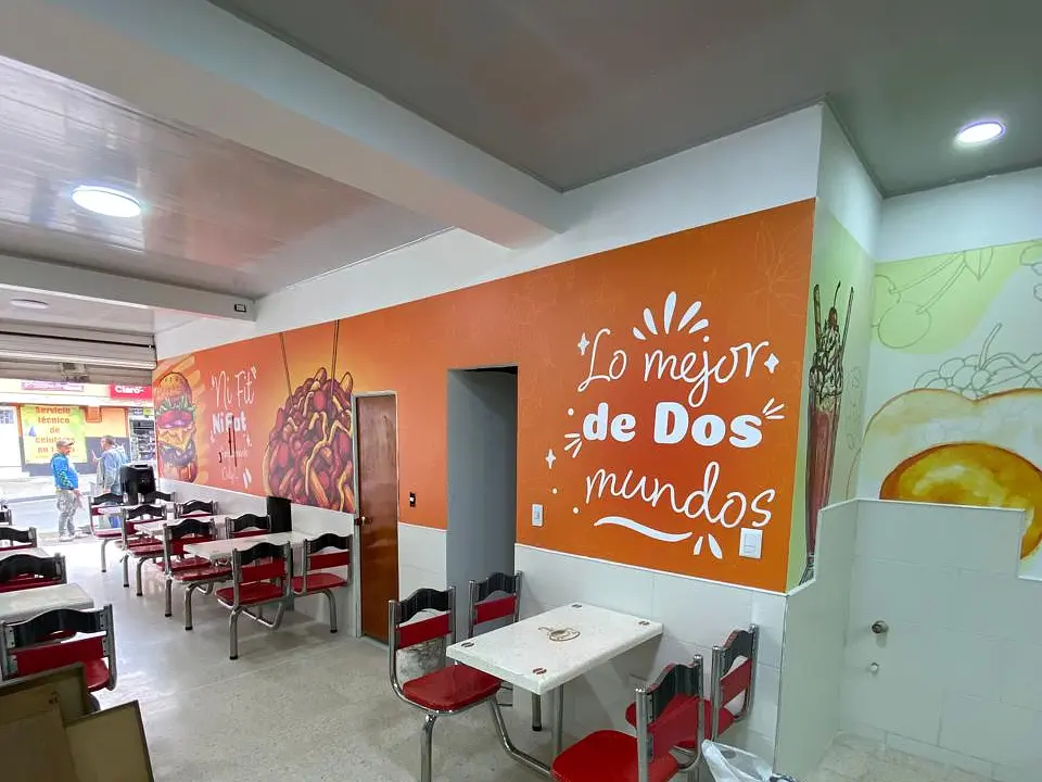 Vista terminada del muro naranja y el mobiliario del punto de venta